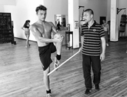 Kung Fu master at Kung Fu bootcamp correcting a students posture and form